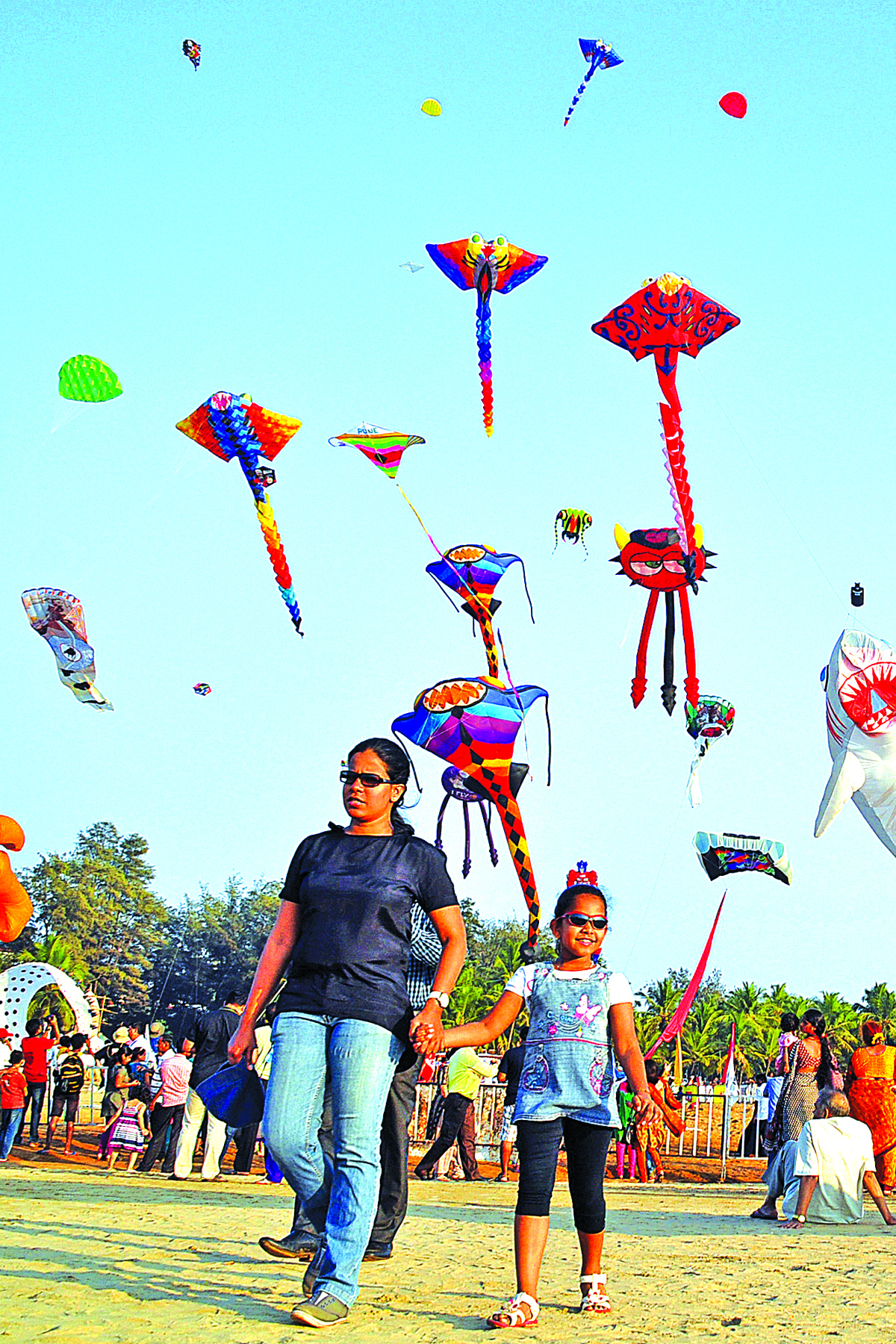 Sky high: A family walks amidst a variety of shapes and sizes of kites at the International Super Kite Festival 2015 at Miramar beach on Saturday.  Photo by: Vincent Braganza
