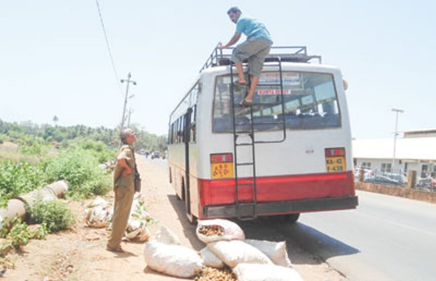 A Karnataka state transport bus unloads vegetable stocks near the Polem border.