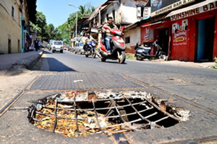 A broken chamber cover lies exposed posing threat to pedestrians