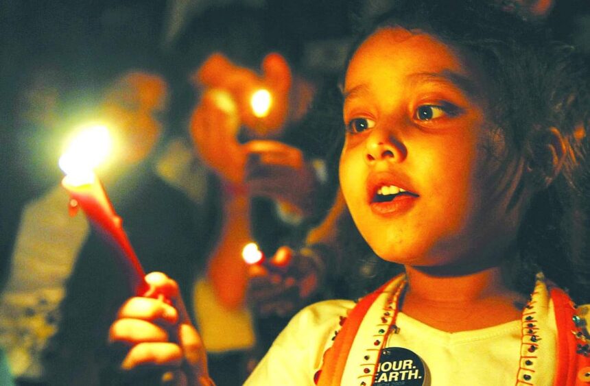 A child lights candles during an Earth Hour campaign in Mumbai on Saturday. Dozens of Indians and citizens world-wide lit candles to observe Earth Hour and called for voluntary action against climate change. 1 A child lights candles during an Earth Hour campaign in Mumbai on Saturday. Dozens of Indians and citizens world-wide lit candles to observe Earth Hour and called for voluntary action against climate change.