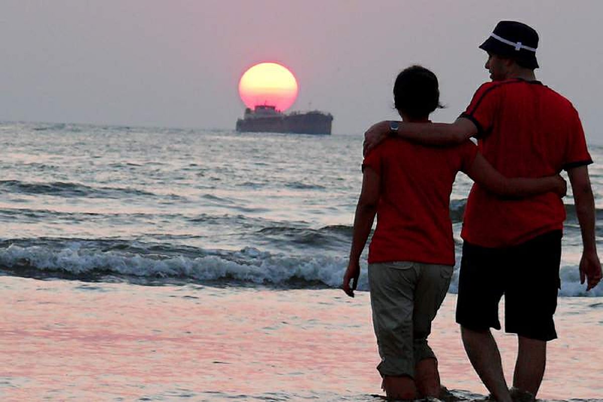 A couple wades through Miramar waters as sun sets 2008