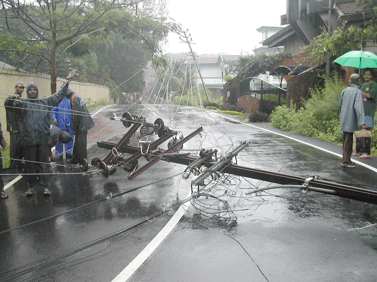 A high tension electric pole lying on the road at Monte Hill, Margao after hit by an uprooted tree.