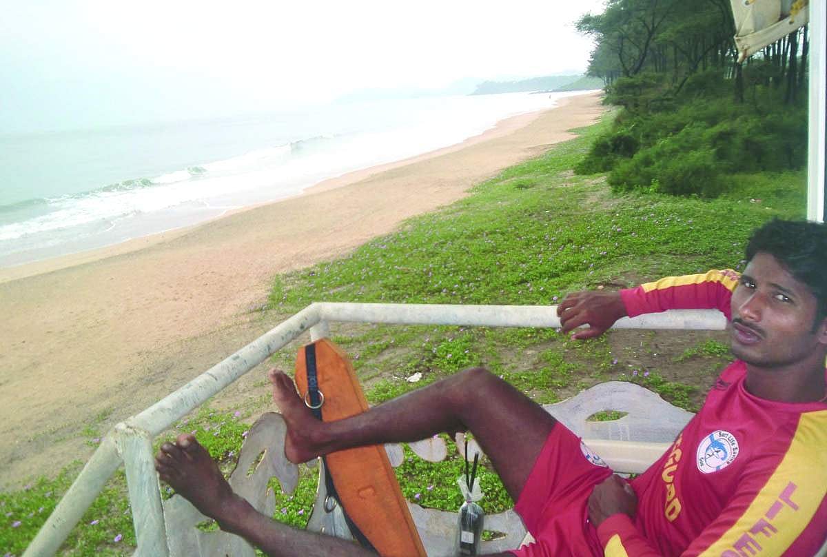 A lifeguard stationed at the watch tower along the empty Galgibaga beach.