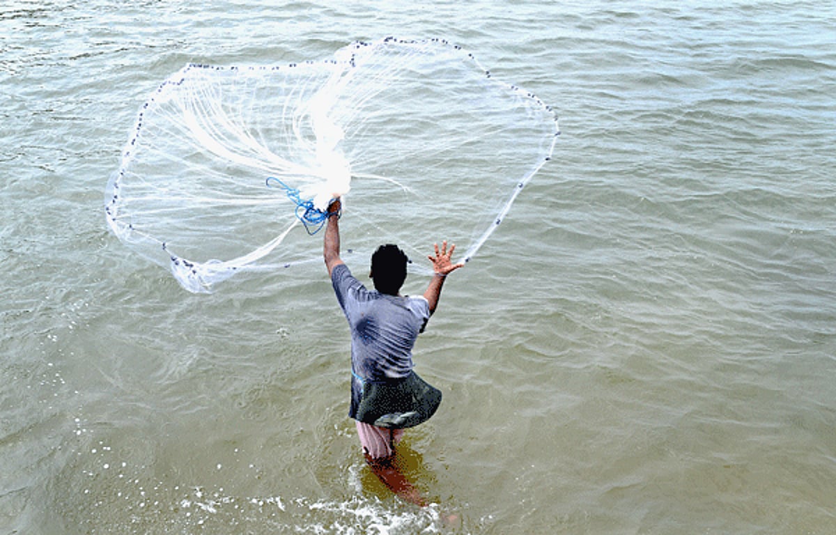A local fisherman casts his fishing net, locally known as pagear, hoping for a catch off Baga beach on Wednesday