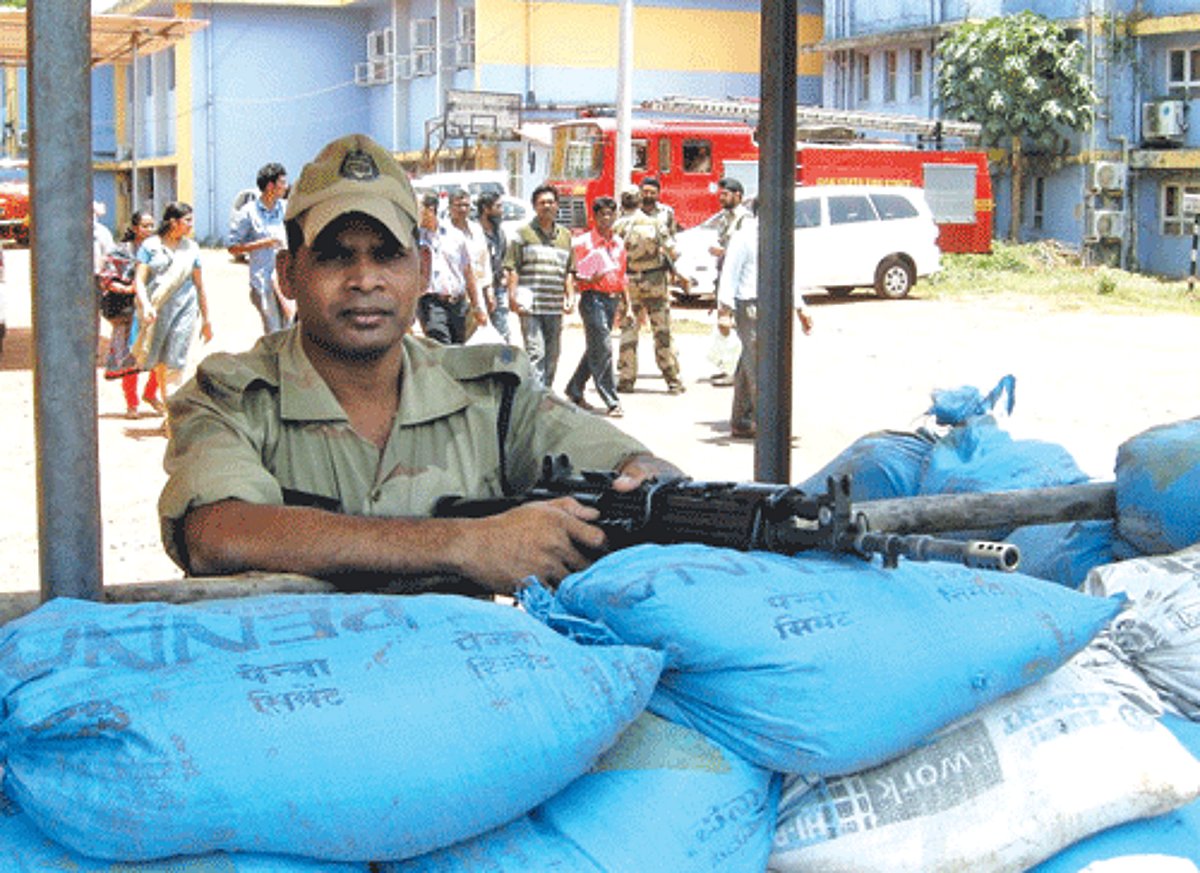 A para military personnel with machine gun mans a bunker erected at the Kare College of Law, where presently the EVMs of the South Goa Lok Sabha constituency are housed
