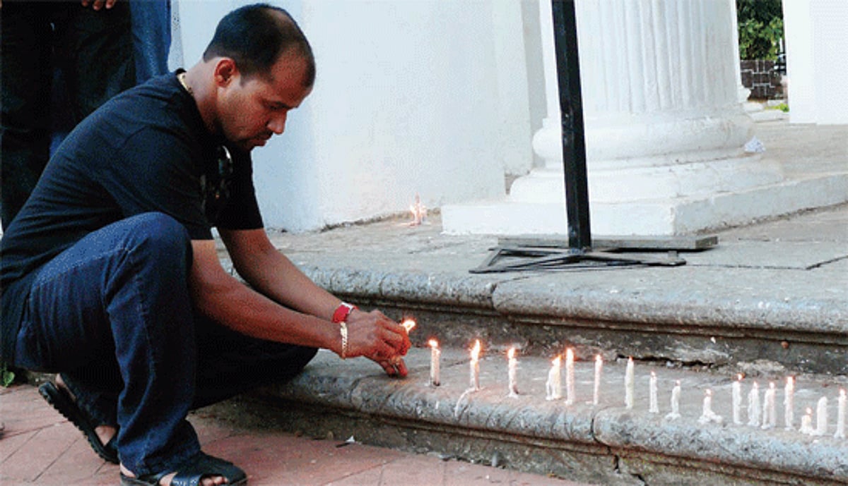 A relative of Cypriano lighting candles at Azad Maidan on the 1st death anniversary of Cypriano seeking justice in his custodial death.