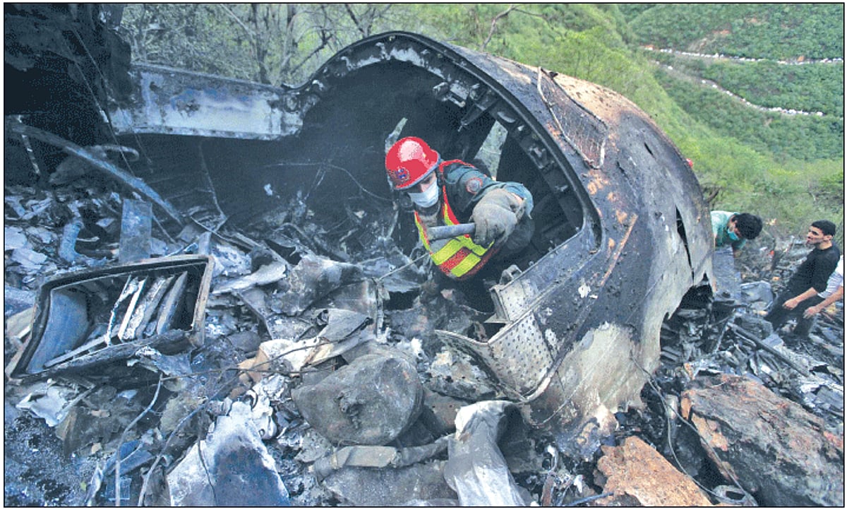 A rescue worker searches the wreckage of the Airblue passenger plane which crashed on the outskirts of Islamabad on Wednesday.