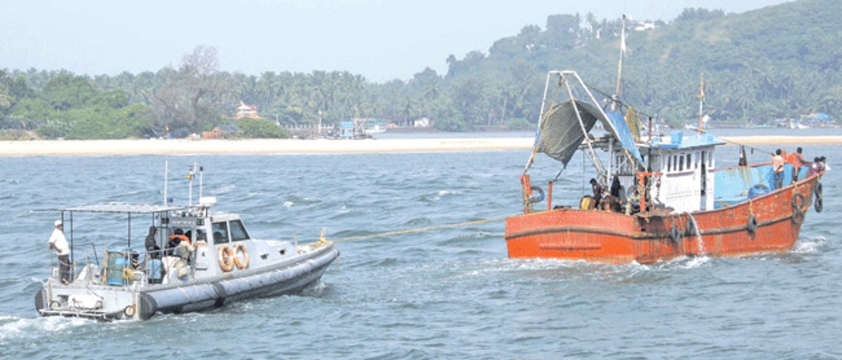 A seized fishing vessel seen towing the coastal police interceptor boat to the Betul fishing jetty.