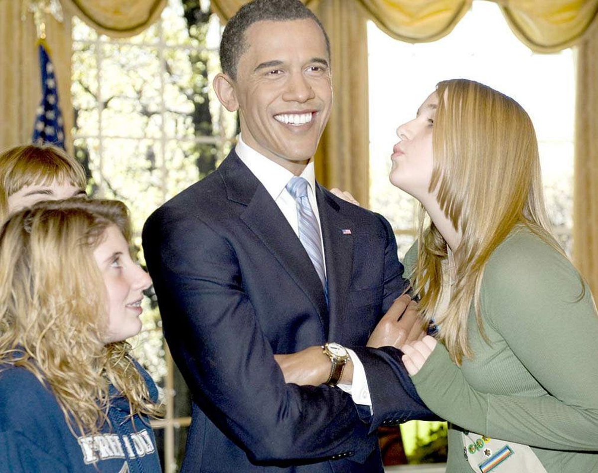 A visitor to Madame Tussaud's New York pretends to kiss wax figure of US President-elect Barack Obama on Thursday in New York City.