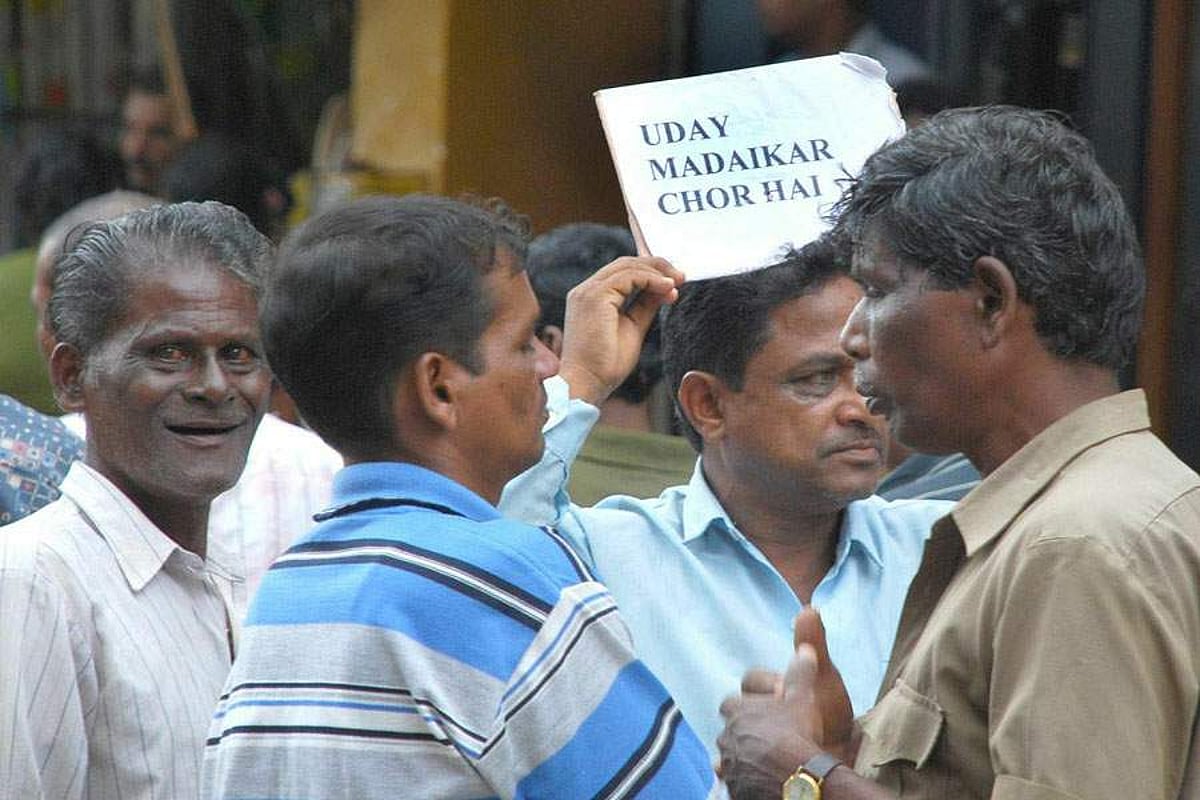 A worker displays a placard, expressing his resentment towards a corporator outside the CCP building in Panjim on Friday.       Photo by Rozario Estibeiro