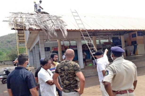Activists thatch roof of Canacona bus stand with palm leaves