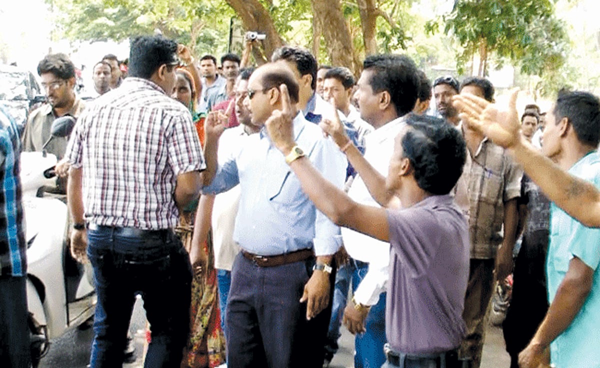 Agitated furniture owners and other vendors seen directing their ire against a representative of an NGO.