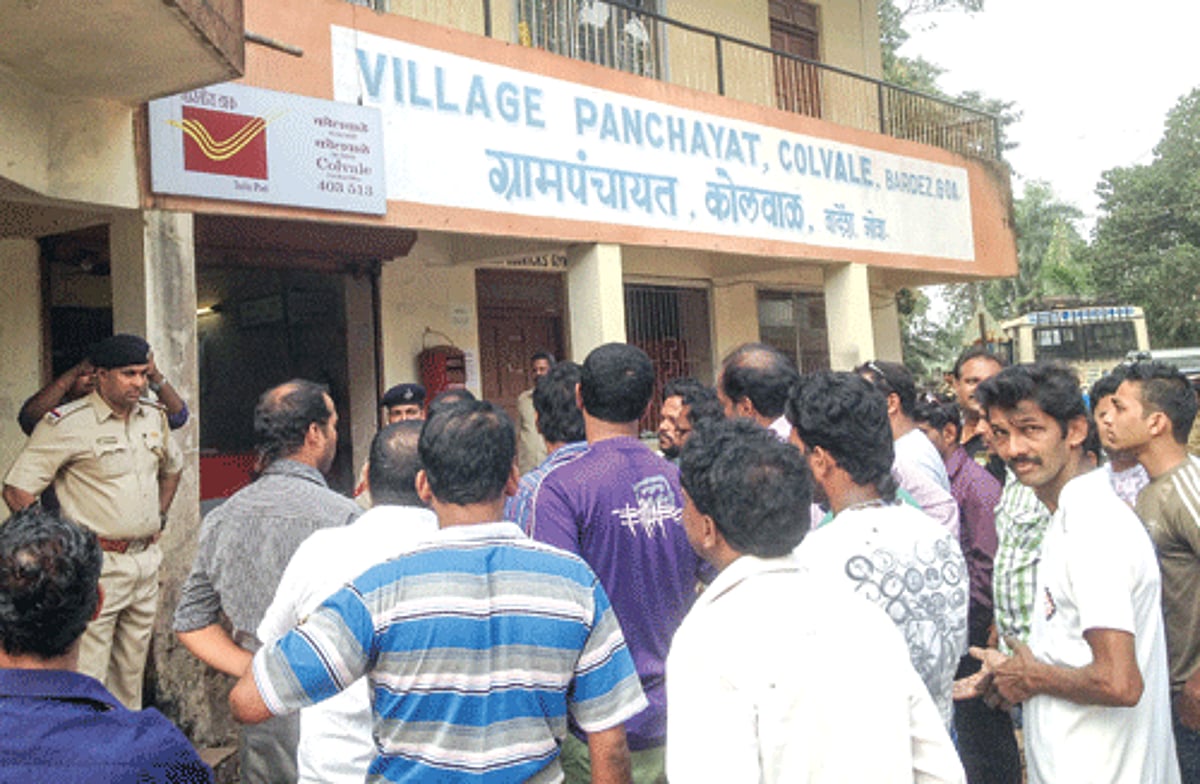 Agitating residents of Colvale stage a protest outside the panchayat building demanding demolition of illegal scrap yards in the village
