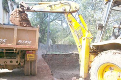 An excavator used to dig the ground for the construction of a septic tank.