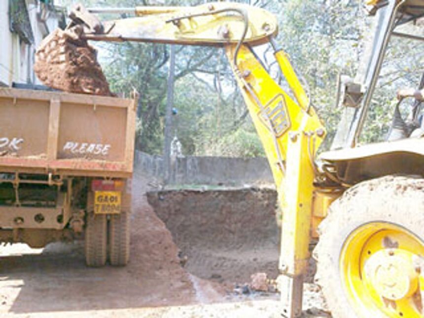 An excavator used to dig the ground for the construction of a septic tank.