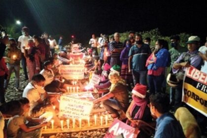 Anti-coal protestors sit on tracks on Liberation Day eve