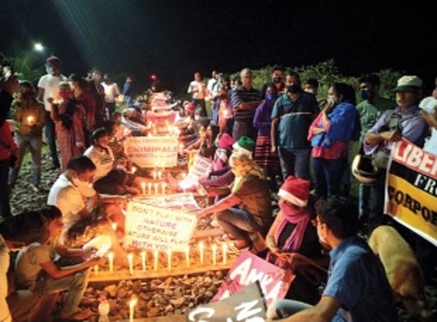 Anti-coal protestors sit on tracks on Liberation Day eve