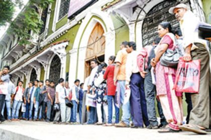 Applicants stand in a queue to submit their application forms for different posts