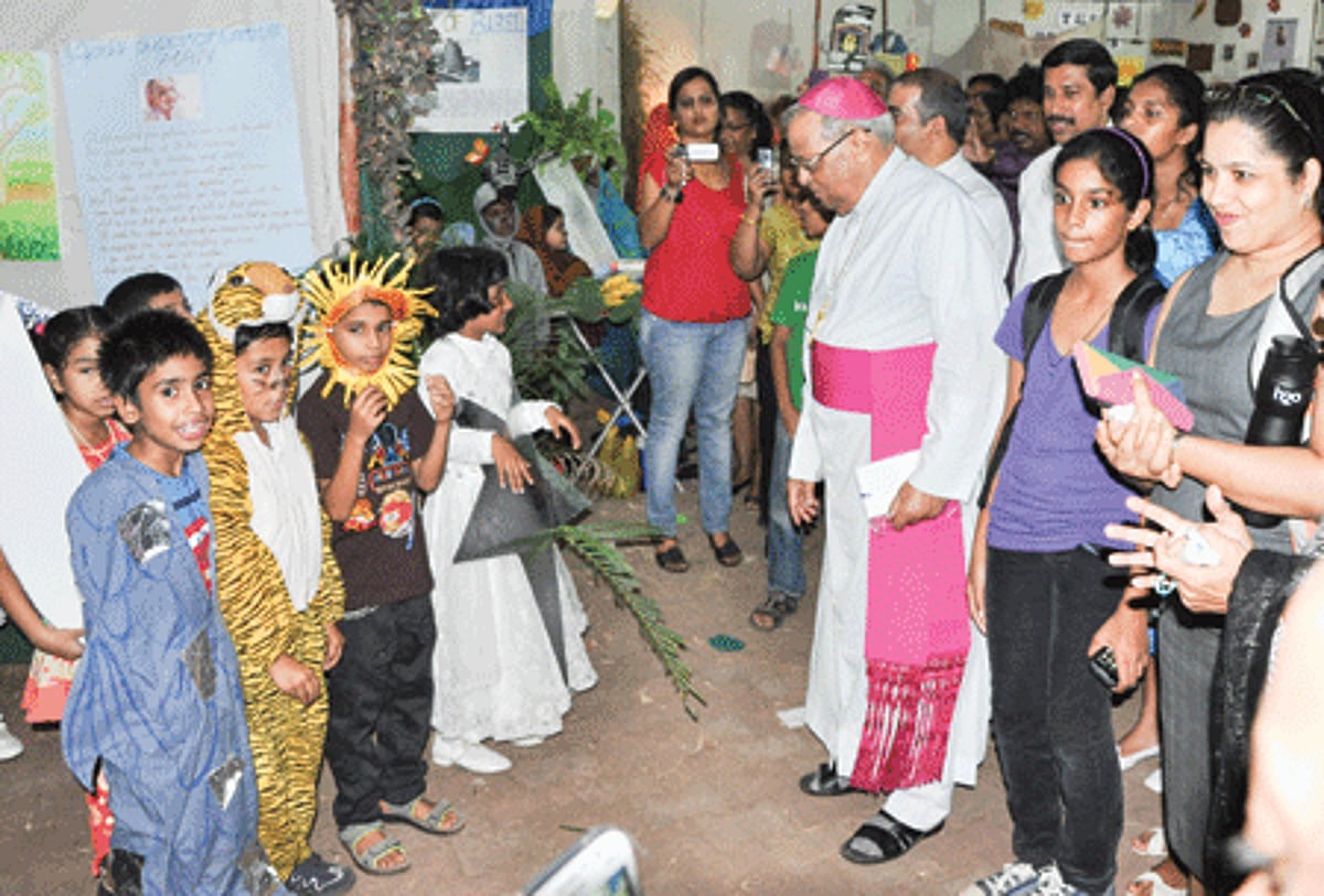 Archbishop Emeritus Dr Raul Gonsalves appreciates the efforts of Catechism children depicting the story of Salvation at the Faith Exhibition at Porvorim.