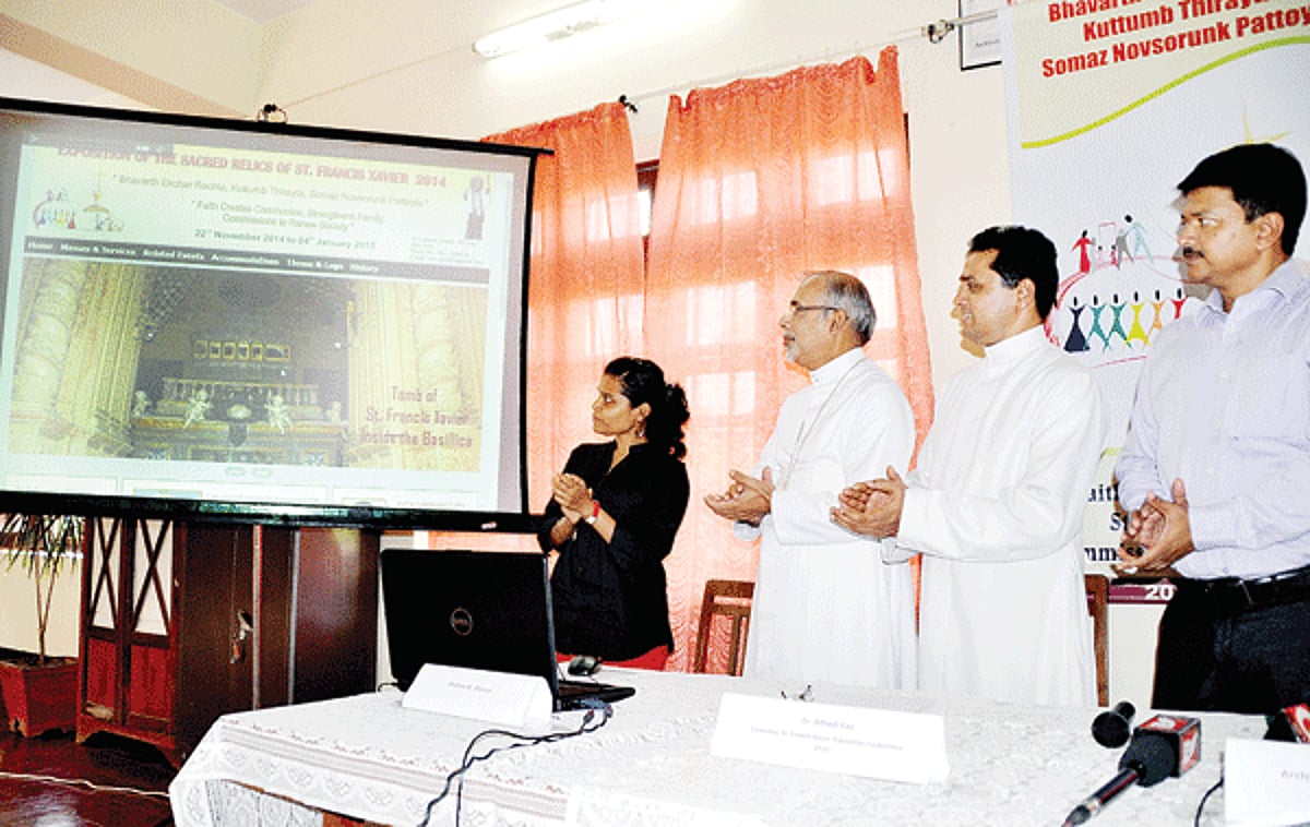 Archbishop Filipe Neri Ferrao launching the official website of the Exposition of the Sacred Relics of St Francis Xavier 2014 in the presence of Fr Alfred Vaz, Convenor St Francis Xavier Exposition Committee 2014 and Elvis Gomes, Member of the committee.