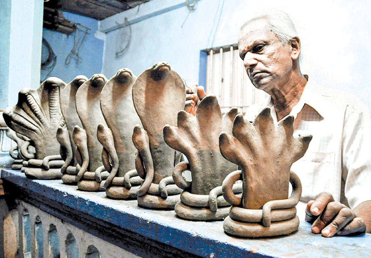 Artist Maheshwar Shinde works on clay replicas of Naag (cobra) at his residence in Khorlim, Mapusa, in preparation for the Naag Panchami festival. Naag Panchami is celebrated on the bright fifth day of the moonlit-fortnight of the Hindu month of Shravan,