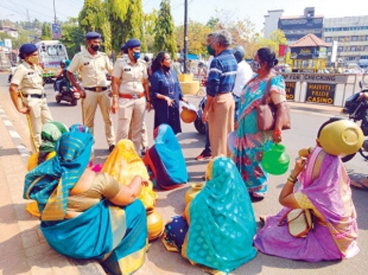 Assagao women sit on road in  protest outside Mapusa PWD office