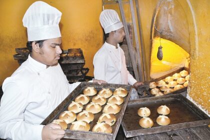 Bakers bake hot cross buns at a bakery in Panjim on Wednesday. Hot cross buns are traditionally eaten on Maundy Thursday, a day before Good Friday.