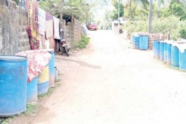 Barrels lined up along narrow roads of Ashewada in Bethora as households face acute water shortages