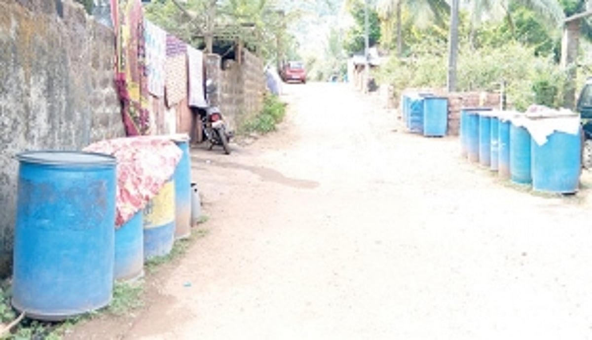 Barrels lined up along narrow roads of Ashewada in Bethora as households face acute water shortages