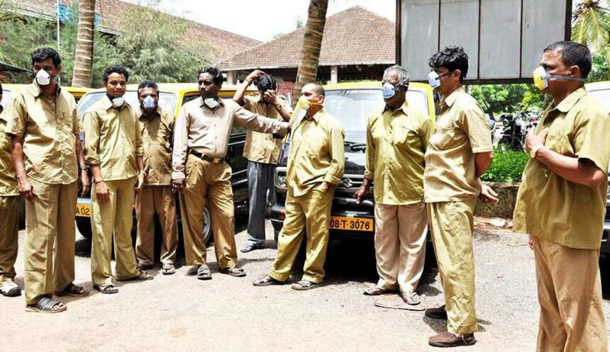 Black and yellow taxi operators at the Margao railway station wearing masks.     Photo by: Santosh Mirajkar