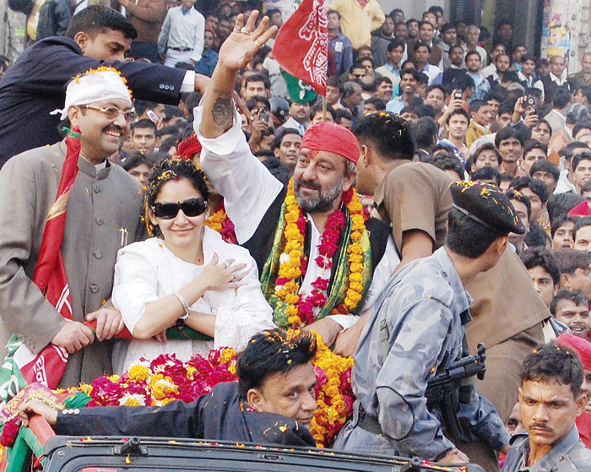 Bollywood star Sanjay Dutt accompanied by his wife Manyata waves to the crowd during a pre-election road show in Lucknow on Saturday.