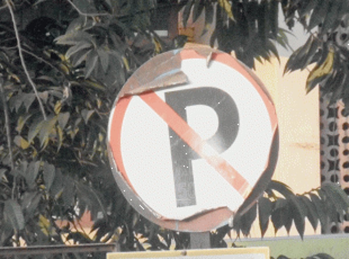 Branches covering signboard chopped