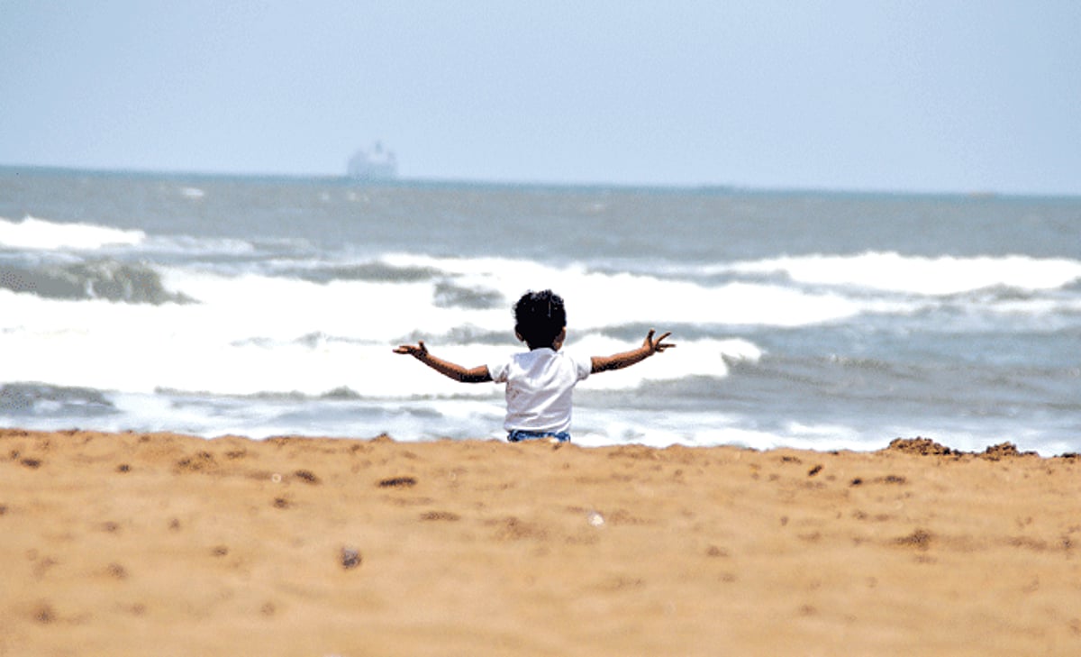 CHILDHOOD BLUES: A child enjoys the spectacular view of the waves at Miramar beach on Thursday.