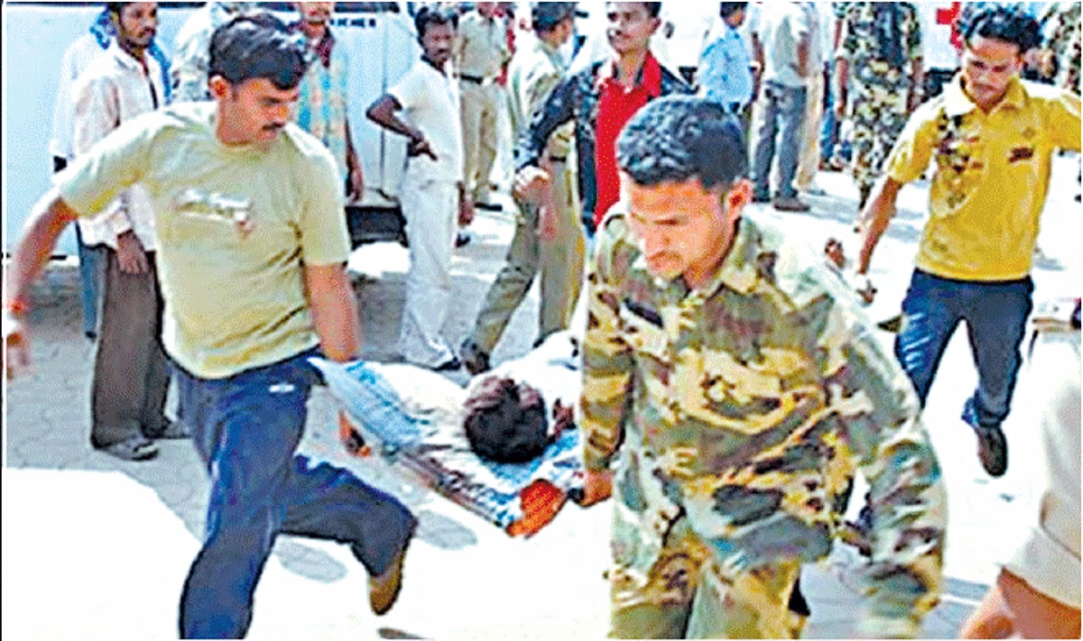 CRPF jawans carry the injured to hospital.