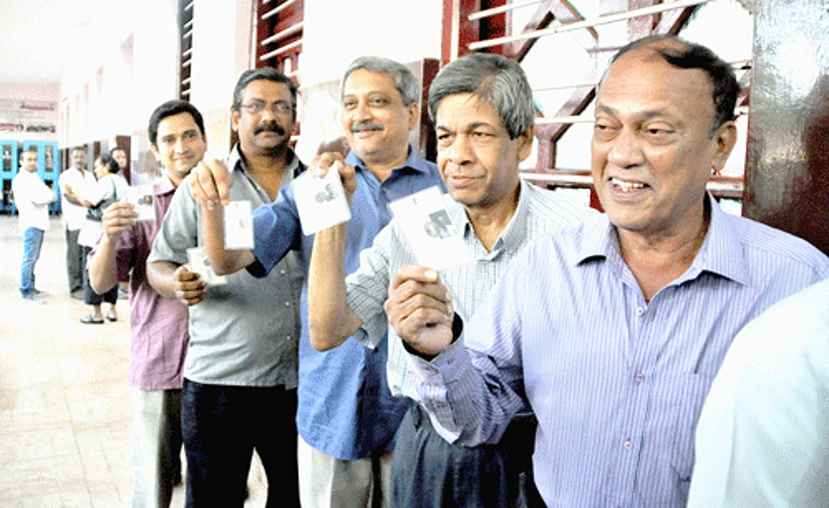 Chief Minister Manohar Parrikar alongwith other voters shows his EPIC card before casting his vote at Panjim on Saturday.