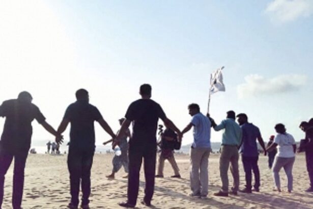 Children form a chain to protect their Mai