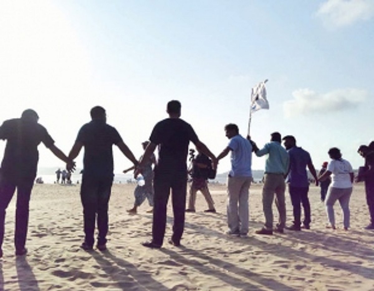 Children form a chain to protect their Mai