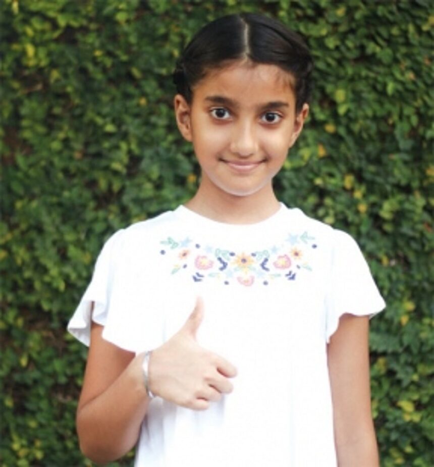 Clasping the racquet in her little hands…