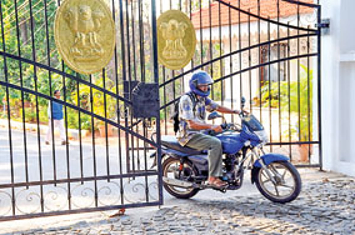 Claude Alvares (on motorbike) and Ramesh Gauns (behind) leave the Raj Bhavan