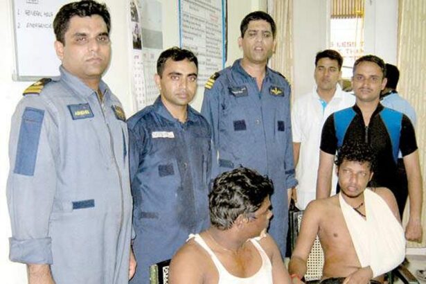 Coast Guard aircrew along with the two rescued anglers.