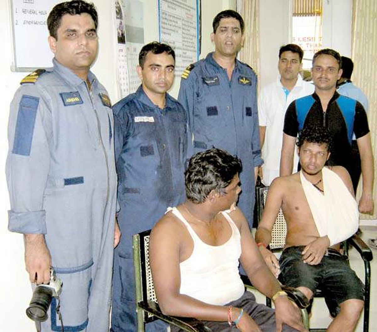 Coast Guard aircrew along with the two rescued anglers.