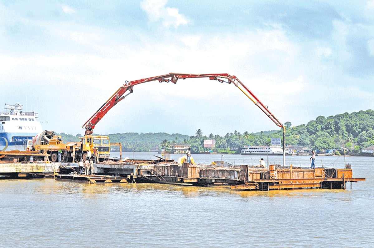 Concrete is pumped from the concrete mixer for a new platform for the proposed Captain of Ports jetty in Panjim.