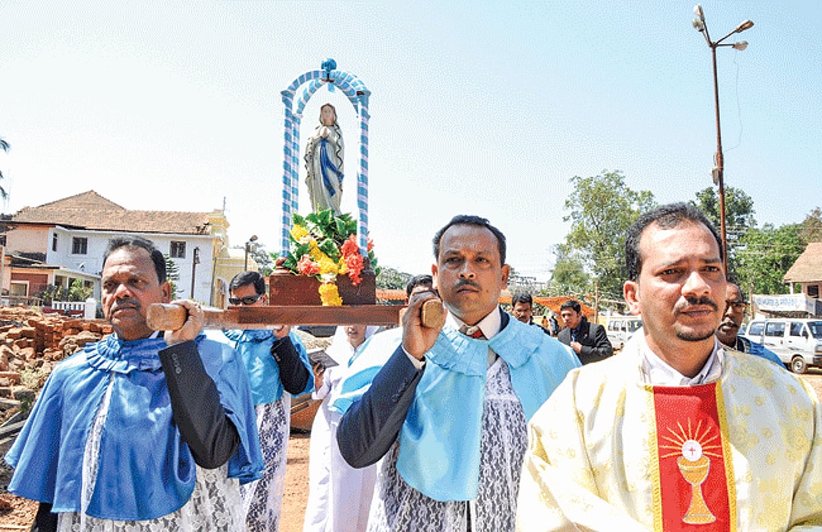 Confrariars along with the main celebrant Fr. Kevin Rodrigues carry the statue of Our Lady of Lourdes in a procession on the occasion of the feast at Valpoi on Tuesday.