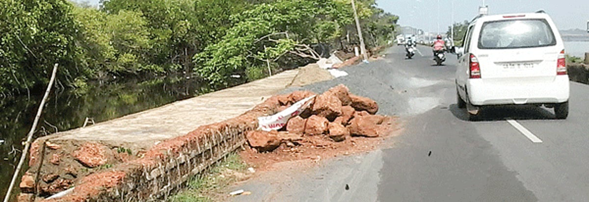 Construction material to erect a retaining wall is lying alongside the road for many days, posing a danger to vehicular traffic along the Ribandar-Panjim road.