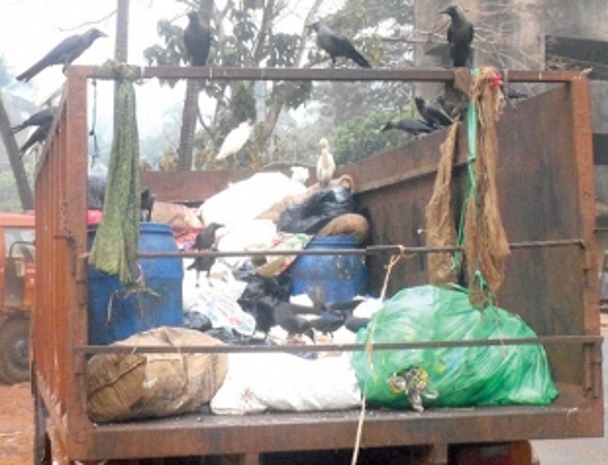 Cover garbage vehicles with tarpaulin while moving