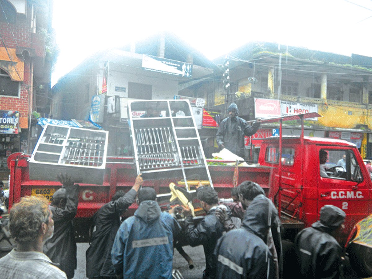 Curchorem-Cacora Municipal Council workers load confiscated goods in the vehicle during the drive.