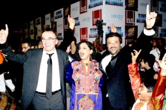 Danny Boyle the Irish-English director of Slumdog Millionaire, Bollywood actress Shabana Azmi and actor Anil Kapoor dance during the premiere of the movie, in Mumbai on Thursday.