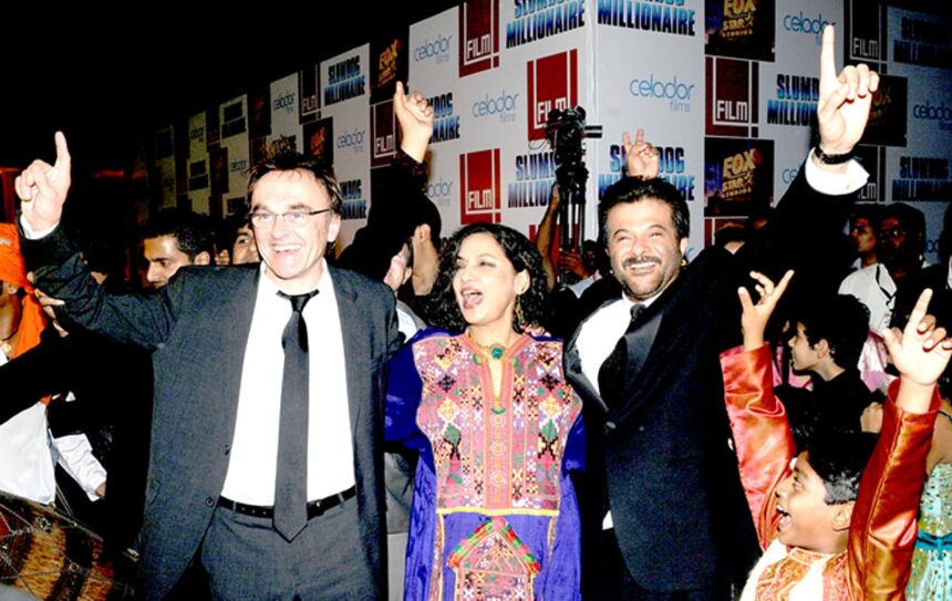 Danny Boyle the Irish-English director of Slumdog Millionaire, Bollywood actress Shabana Azmi and actor Anil Kapoor dance during the premiere of the movie, in Mumbai on Thursday.