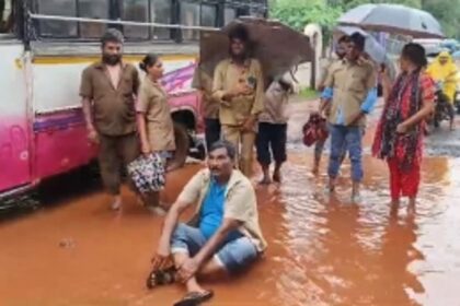 Daring bus owner sits in a pothole to protest against bad roads in Assagao