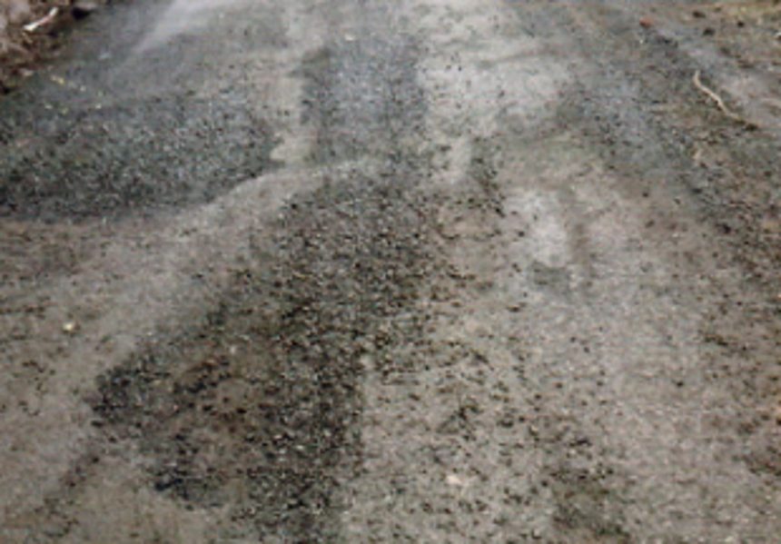 Despite showers, black topping of road in Bhati continues